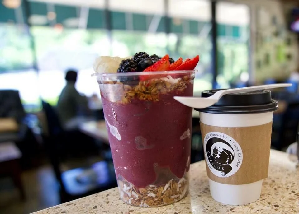 An açaí bowl and a Cyrano's coffee on the counter