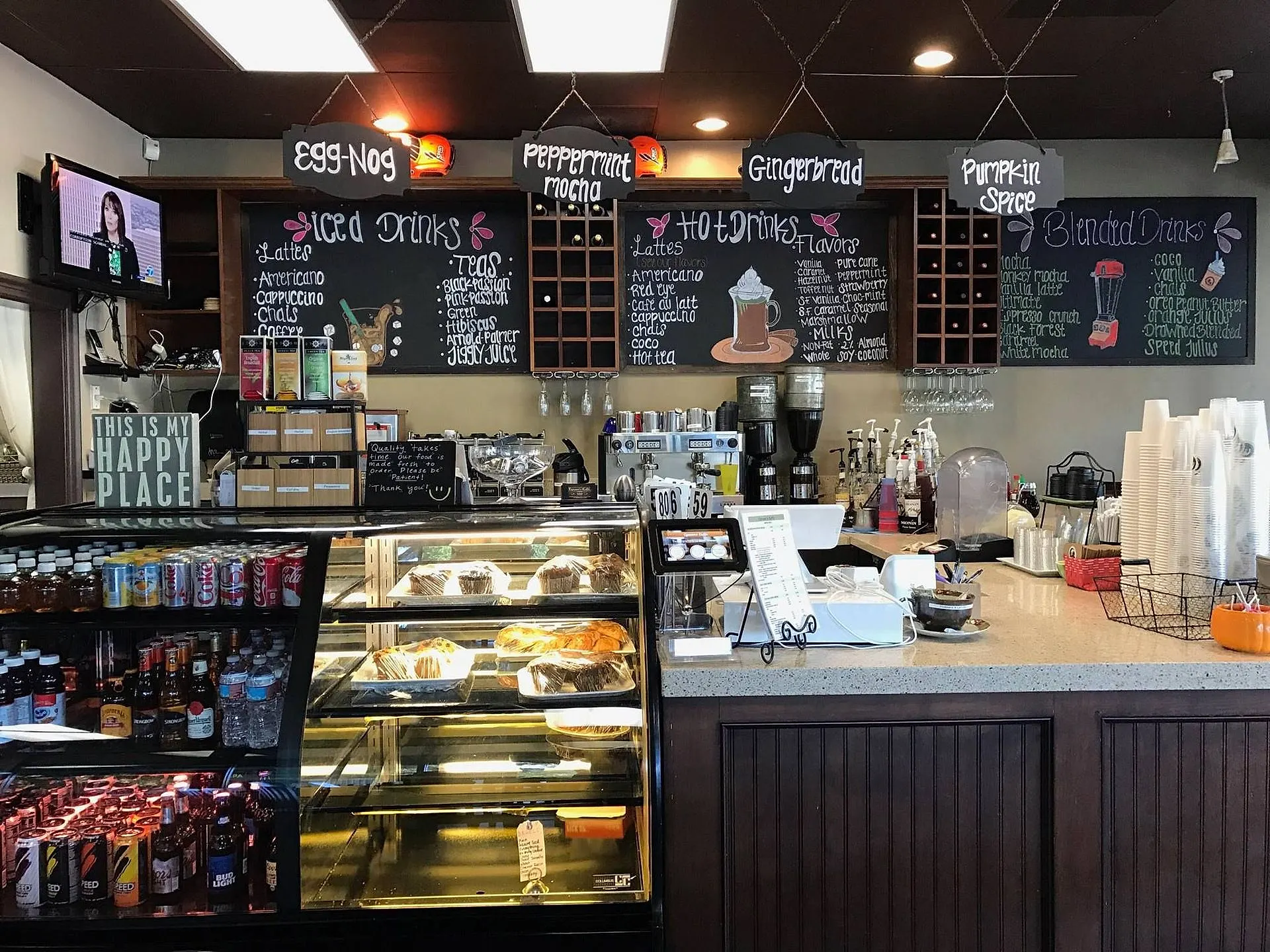 The Cyrano's Caffe front counter: chalkboard drink menus, the espresso machines and the pastry case