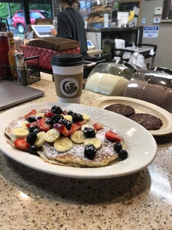 Pancakes with berries and powdered sugar at the Cyrano's counter