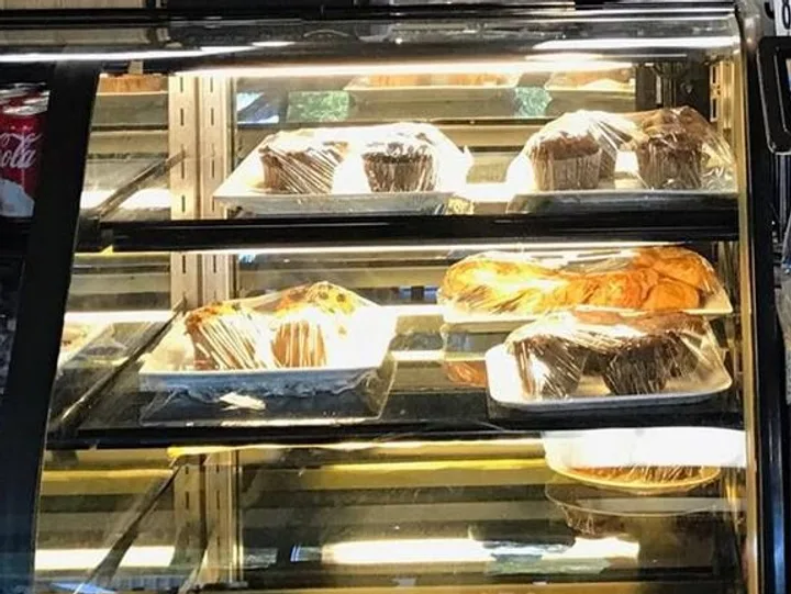 Muffins and croissants in the pastry case